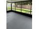 Screened-in porch featuring black framing overlooks the backyard and greenery at 124 Cinnamon Dr, Orlando, FL 32825