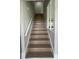 A carpeted stairway with white handrails at 124 Cinnamon Dr, Orlando, FL 32825