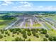 Wide aerial shot of a sprawling new home community with green spaces and modern home designs at 1538 Mermaid Way, Haines City, FL 33844