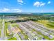 A high aerial shot showcasing a new construction residential neighborhood featuring a nearby lake at 1538 Mermaid Way, Haines City, FL 33844