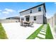 Exterior shot of the backyard with a paved patio and well-maintained lawn at 1538 Mermaid Way, Haines City, FL 33844
