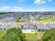 Aerial view of a backyard with a patio featuring outdoor furniture in a new residential community at 1538 Mermaid Way, Haines City, FL 33844