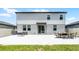 Grassy backyard with large patio, perfect for outdoor entertaining at 1538 Mermaid Way, Haines City, FL 33844