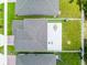 Aerial view of the home's backyard featuring a patio and landscaped lawn with a dining set for outdoor entertaining at 1538 Mermaid Way, Haines City, FL 33844