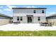 Spacious backyard featuring a large paved patio and a well-maintained lawn at 1538 Mermaid Way, Haines City, FL 33844
