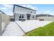 Backyard with a stone-paved patio, grassy area, and walkway at 1538 Mermaid Way, Haines City, FL 33844