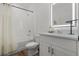 Bright bathroom with white subway tile, modern vanity, and shower-tub combination at 1538 Mermaid Way, Haines City, FL 33844