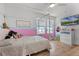 Bright bedroom features a unique canopy bed, a playful pink color scheme, a flat screen television and large windows at 1538 Mermaid Way, Haines City, FL 33844