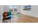 Bright bonus room features wood flooring, white walls, large windows, and colorful play area at 1538 Mermaid Way, Haines City, FL 33844