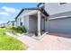Charming two-story home with light-blue shutters, attached garage, and landscaped lawn at 1538 Mermaid Way, Haines City, FL 33844