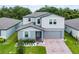 Charming two-story home with light-blue shutters, attached garage, and well-manicured lawn at 1538 Mermaid Way, Haines City, FL 33844
