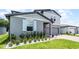 Charming two-story home with light-blue shutters, attached garage, and landscaped lawn at 1538 Mermaid Way, Haines City, FL 33844