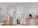 Second floor hallway with white walls, wood floors, windows and lots of space at 1538 Mermaid Way, Haines City, FL 33844