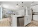 View of living room and kitchen with white countertops, stainless appliances and island seating at 1538 Mermaid Way, Haines City, FL 33844