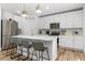 Modern kitchen featuring stainless steel appliances, quartz countertops, and eat-in island at 1538 Mermaid Way, Haines City, FL 33844