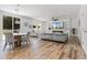 Open-concept living room with wood floors, electric fireplace, and ample natural light at 1538 Mermaid Way, Haines City, FL 33844