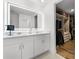 The main bathroom features a double sink vanity, large mirror, and a walk in closet at 1538 Mermaid Way, Haines City, FL 33844