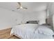 This bright main bedroom features wood floors, neutral walls, accent furniture, and natural light at 1538 Mermaid Way, Haines City, FL 33844