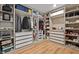 This large walk-in closet includes custom shelving, drawers, and organized storage space at 1538 Mermaid Way, Haines City, FL 33844