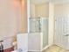 Bathroom featuring a glass-enclosed shower, toilet, and white door at 162 Seneca Point Trl, Kissimmee, FL 34746