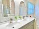 Bathroom featuring double sink vanity with modern faucet fixtures and a window at 162 Seneca Point Trl, Kissimmee, FL 34746