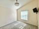 Comfortable bedroom with carpet, window, and ceiling fan with lights at 162 Seneca Point Trl, Kissimmee, FL 34746