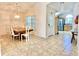 Bright dining room with tile floors, a window and a view into the kitchen with stainless steel appliances at 162 Seneca Point Trl, Kissimmee, FL 34746