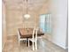 Cozy dining room with a large wooden table, bright light fixture and decorative light at 162 Seneca Point Trl, Kissimmee, FL 34746
