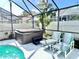 Hot tub and outdoor lounge seating under a screened in enclosure by the pool at 162 Seneca Point Trl, Kissimmee, FL 34746