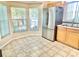 Bright eat-in kitchen area with stainless steel fridge and view of the lush backyard at 162 Seneca Point Trl, Kissimmee, FL 34746