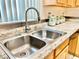 Close up of stainless steel kitchen sink and faucet with granite countertops at 162 Seneca Point Trl, Kissimmee, FL 34746