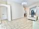 Spacious living room with tile flooring, a view of dining room, kitchen, and a decorative chandelier at 162 Seneca Point Trl, Kissimmee, FL 34746