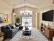 Bright living room with gray sofa, vaulted ceiling, and sliding glass doors to an outdoor patio at 162 Seneca Point Trl, Kissimmee, FL 34746