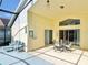 Screened-in patio with lounge chairs and dining table, perfect for outdoor relaxation at 162 Seneca Point Trl, Kissimmee, FL 34746