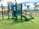 Outdoor playground with green turf and an American flag flying nearby at 162 Seneca Point Trl, Kissimmee, FL 34746