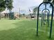 Community playground with swings, slides, and green turf, perfect for Gathering fun at 162 Seneca Point Trl, Kissimmee, FL 34746