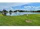 Scenic view of the community pond with a fountain surrounded by lush greenery at 162 Seneca Point Trl, Kissimmee, FL 34746