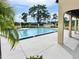 Community swimming pool with palm trees and lounge area, ideal for recreation and relaxation at 162 Seneca Point Trl, Kissimmee, FL 34746