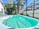Sparkling pool with screened enclosure and lounge chairs for relaxing by the water at 162 Seneca Point Trl, Kissimmee, FL 34746