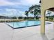 Community pool featuring a zero entry design with shallow water and lush landscaping at 162 Seneca Point Trl, Kissimmee, FL 34746