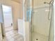 Bathroom shower features tiled walls and floor with a glass door and a walk-in closet at 162 Seneca Point Trl, Kissimmee, FL 34746