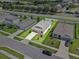 High-angle aerial view of a single-Gathering home featuring a manicured lawn and surrounding streets at 1717 Hilltop Dr, Dundee, FL 33838