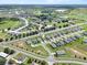 Expansive aerial view of a residential community with single-Gathering homes and green spaces at 1717 Hilltop Dr, Dundee, FL 33838