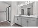 Bright bathroom features a double vanity, black hardware, and a glass-enclosed shower at 1717 Hilltop Dr, Dundee, FL 33838