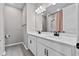 Bathroom with double vanity, white cabinets, modern faucets and hard flooring at 1717 Hilltop Dr, Dundee, FL 33838