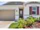 Inviting front entrance with lush landscaping and a decorative 'Welcome' sign at 1717 Hilltop Dr, Dundee, FL 33838