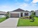 Charming one-story home with a well-manicured lawn and attached two-car garage at 1717 Hilltop Dr, Dundee, FL 33838