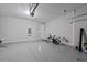 Spacious garage featuring speckled epoxy flooring, high ceilings, and room for multiple vehicles at 1717 Hilltop Dr, Dundee, FL 33838