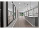 Open-concept kitchen with white cabinetry, stainless steel appliances, and hardwood floors at 1717 Hilltop Dr, Dundee, FL 33838