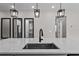Close-up of a kitchen island with modern fixtures and pendant lighting above the sink at 1717 Hilltop Dr, Dundee, FL 33838